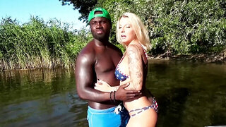 Horny blonde plays with a BBC in the middle of a forest