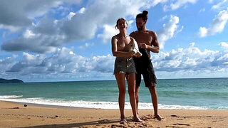 Tattooed hottie and her partner are naked on the beach