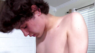 Zealous twink with dark hair playing with his friend