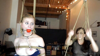 Blonde girl is bound, gagged and tortured by a mistress