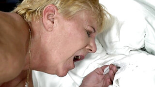 Mature blonde woman is getting fucked by a horny fella