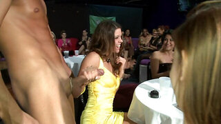 Girls are taking turns sucking off a stripper in a wild sex party