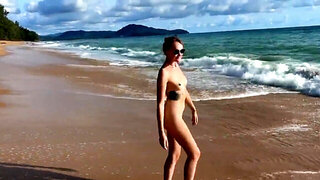 Tattooed hottie and her partner are naked on the beach