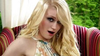A busty blonde girl is taking off her long dress to shake her ass